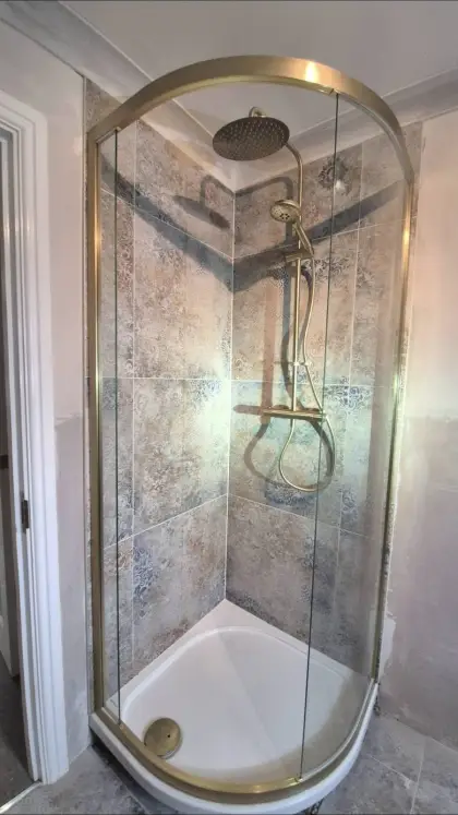 Brushed brass shower in a quadrant enclosure