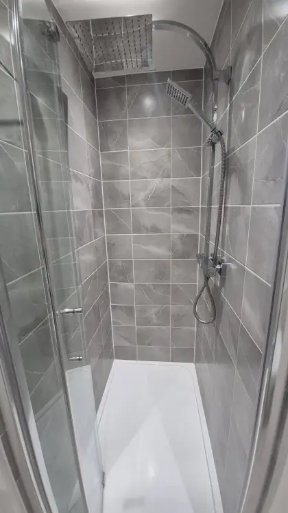Grey tiled shower with rainfall head